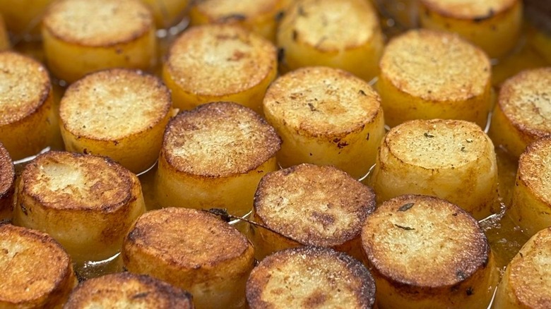 Fondant potatoes in pan