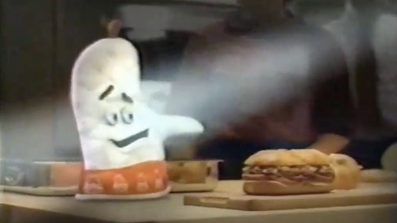 arbys oven mitt mascot presenting a sandwich