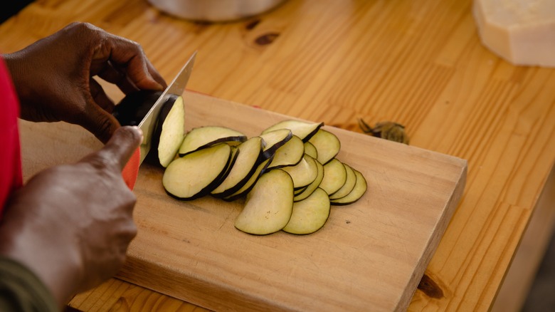 Chopping eggplant with a chef's knife