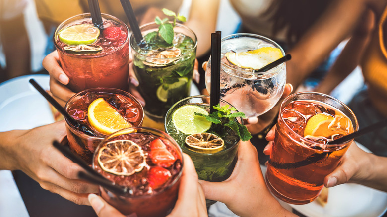 A group of people toasting with alcoholic beverages.