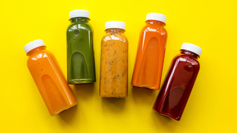 Fruit juice bottles on yellow background