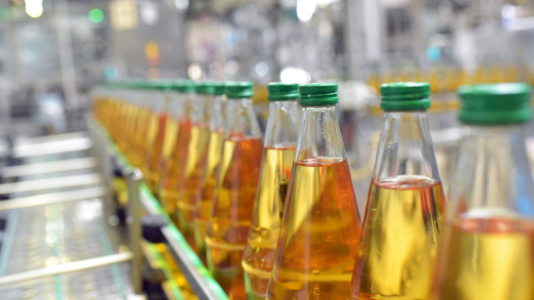 apple juice bottles displayed in a factory