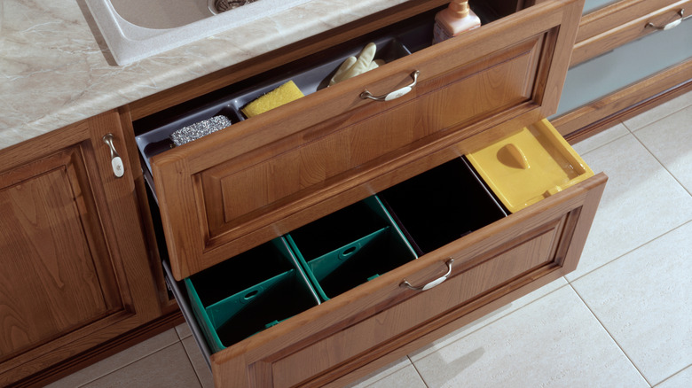 Baskets and bins inside of deep kitchen drawers.