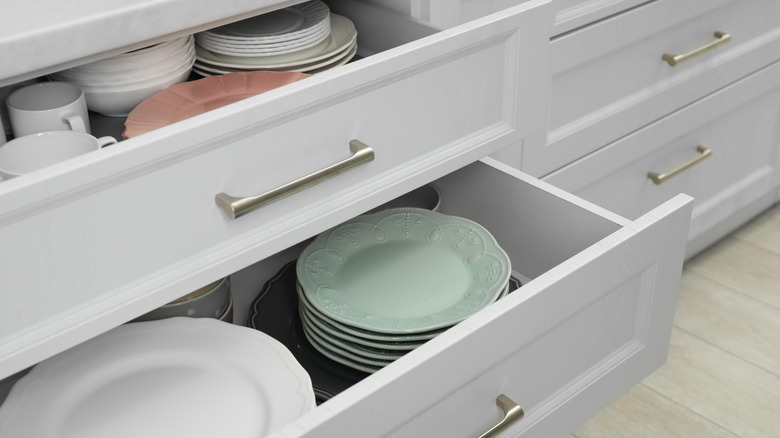 Kitchen drawers with dishes inside.