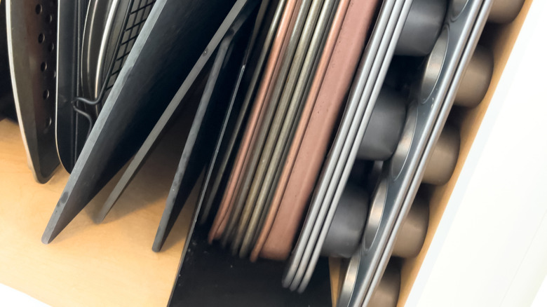 A stack of sheet pans, cooling racks, and other pans.