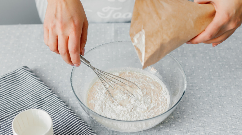 mixing flour into a bowl