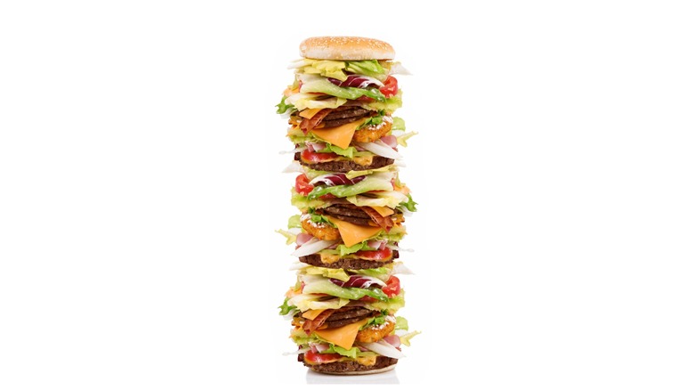 Comically tall burger with lots of toppings