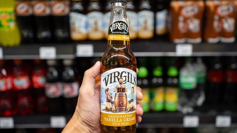 person holding Virgil's Vanilla Cream soda in a store