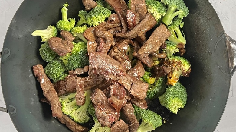 beef and broccoli in wok