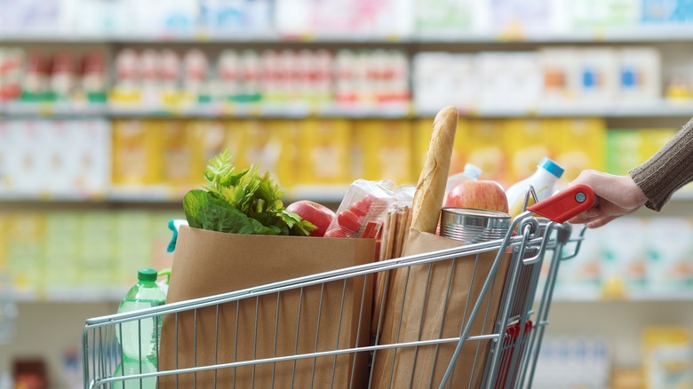 Customer pushing full grocery cart