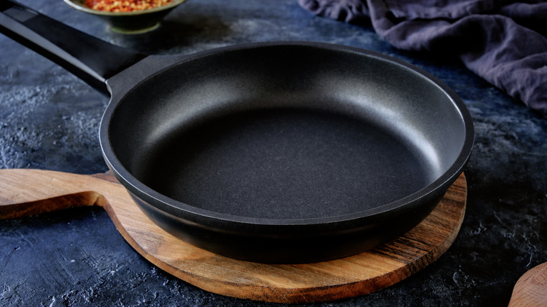 Nonstick pan on wooden board