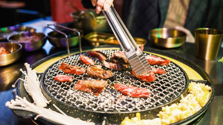 Korean barbecue with tongs