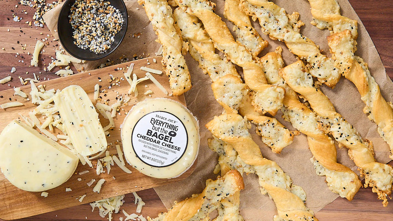 packaged cheese on cutting board next to cheese twists