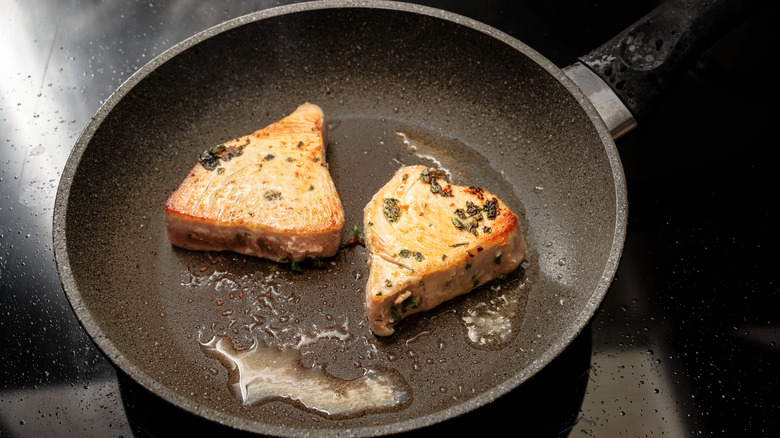 Tuna fillets in grill pan with rosemary