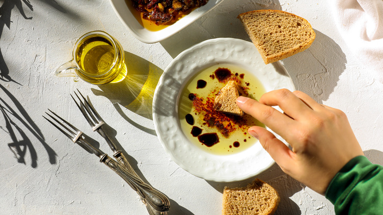 Dipping bread in olive oil