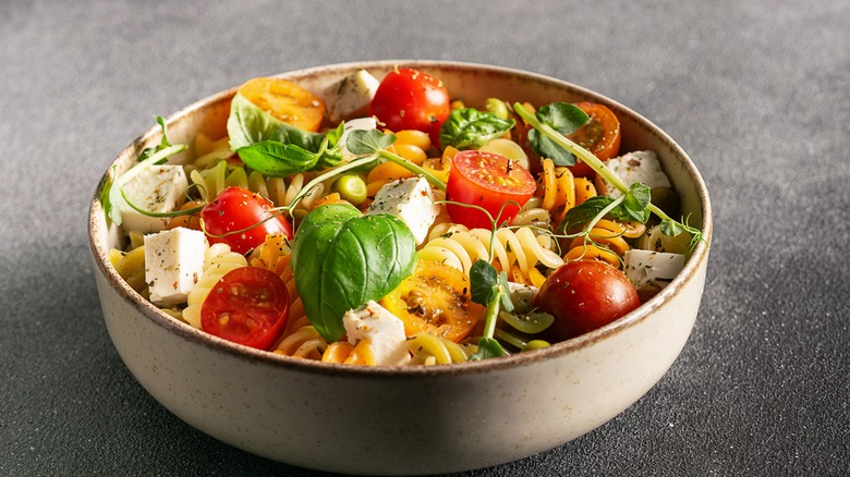 Colorful pasta salad with basil and tomatoes