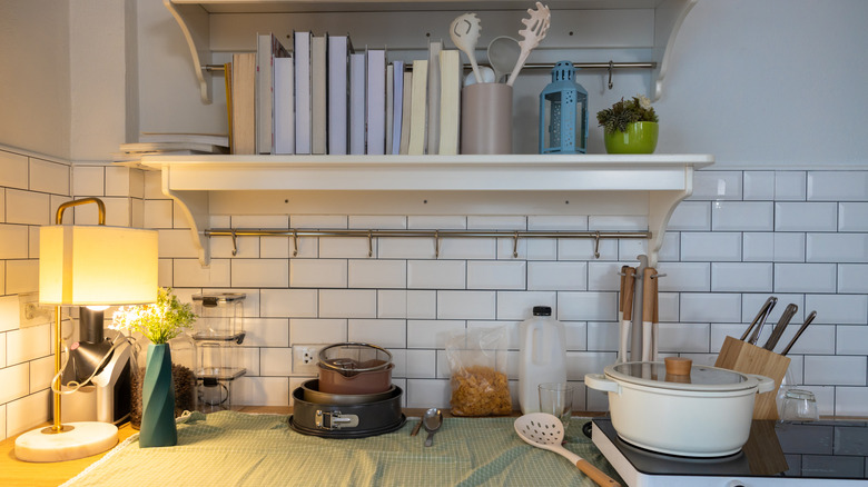 A small floating shelf over a countertop