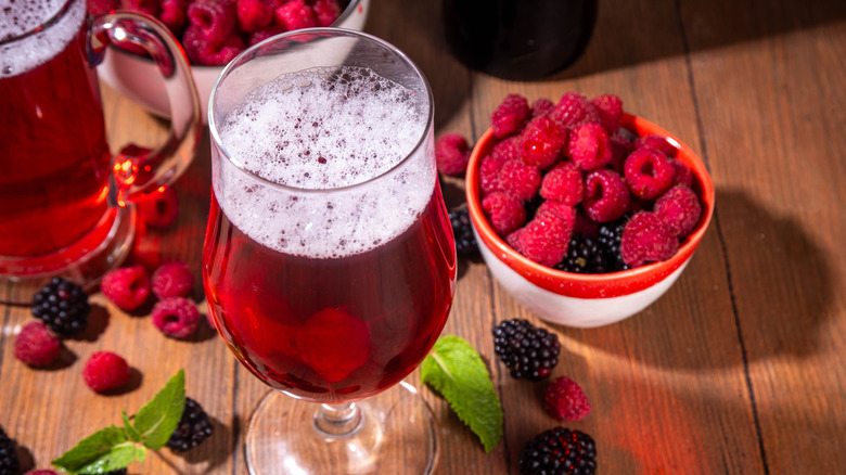 Fruit beer surrounded by berries