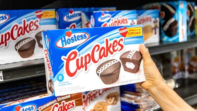 Woman holding box of Hostess Cup Cakes