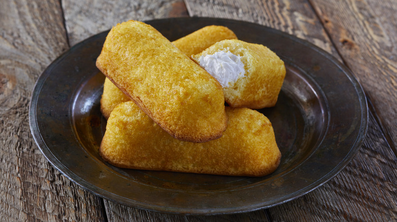 a pile of twinkies on a black plate