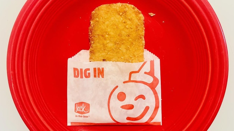 One Jack in the Box hash brown on red plate