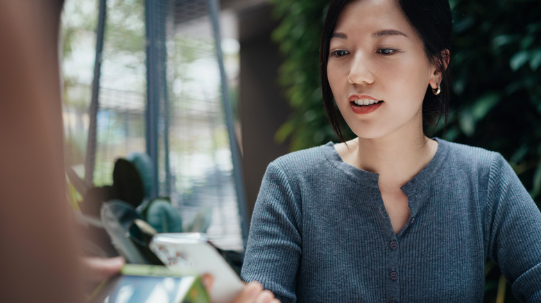 Woman making payment with phone