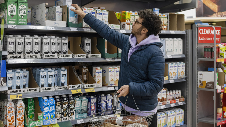 A man shopping for plant based milks