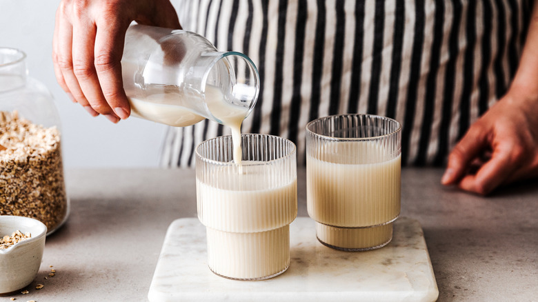 Oat milk being poured into a glass