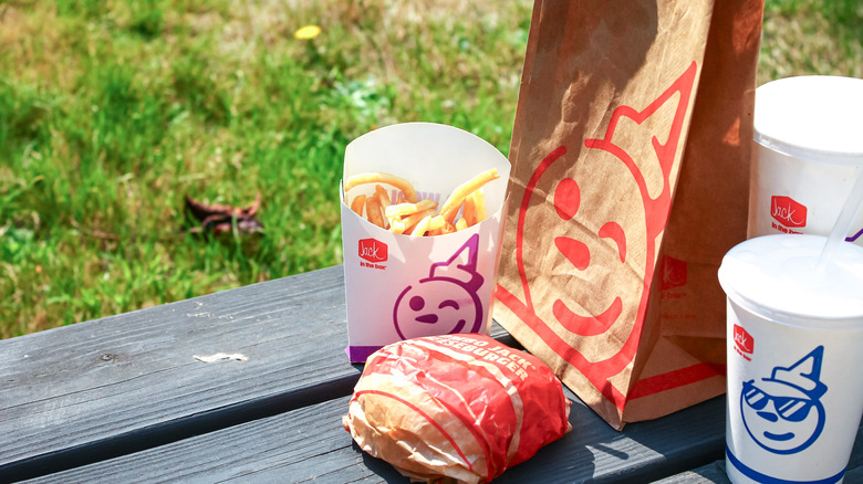 A Jack in the Box takeaway on a wooden bench