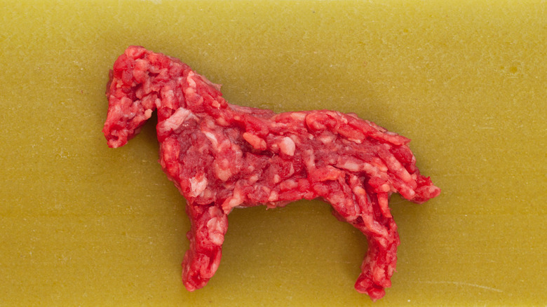 A horse silhouette made out of ground beef
