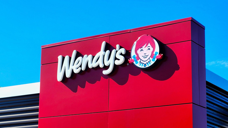A Wendy's restaurant with a blue sky behind