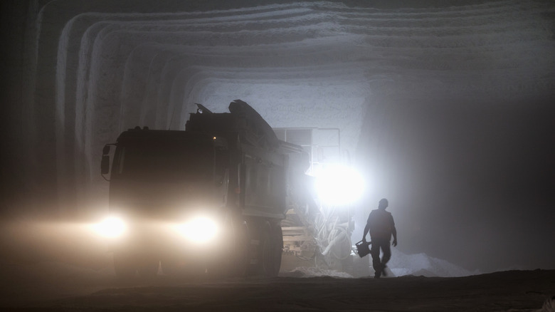 Interior of salt mine with truck and worker