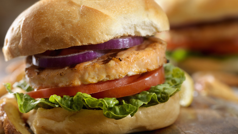 A close-up of a salmon burger