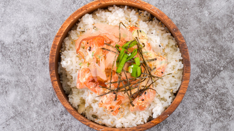 A salmon rice bowl with seaweed and green onion