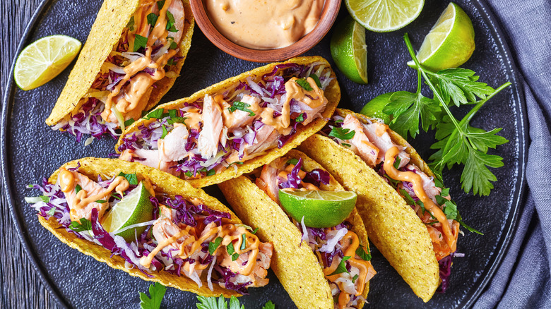 salmon tacos with fresh limes and herbs