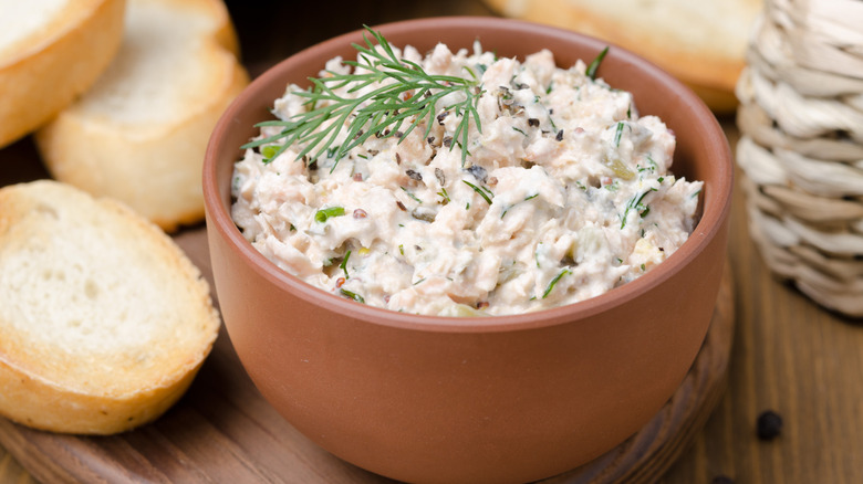 A bowl of salmon dip with dill frond