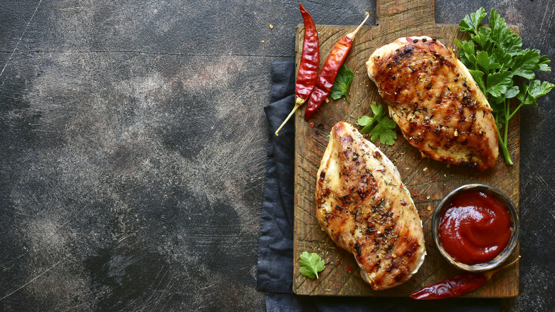 grilled chicken breast on board