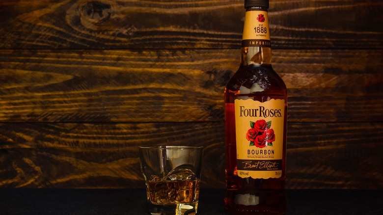 A bottle of Four Roses and glass