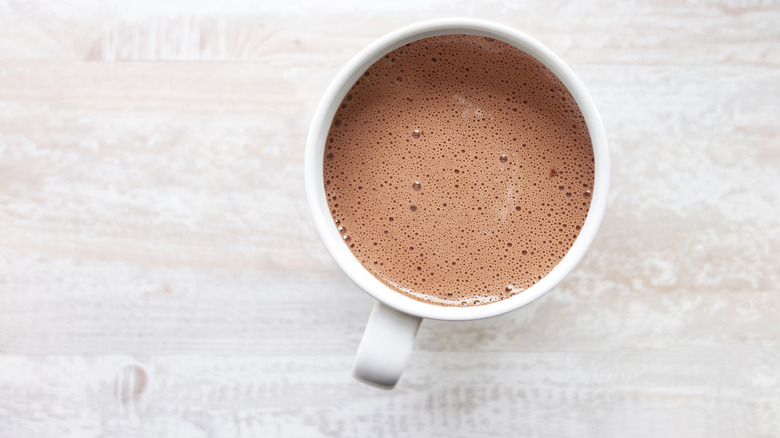 Looking down on a white, hot chocolate mug.