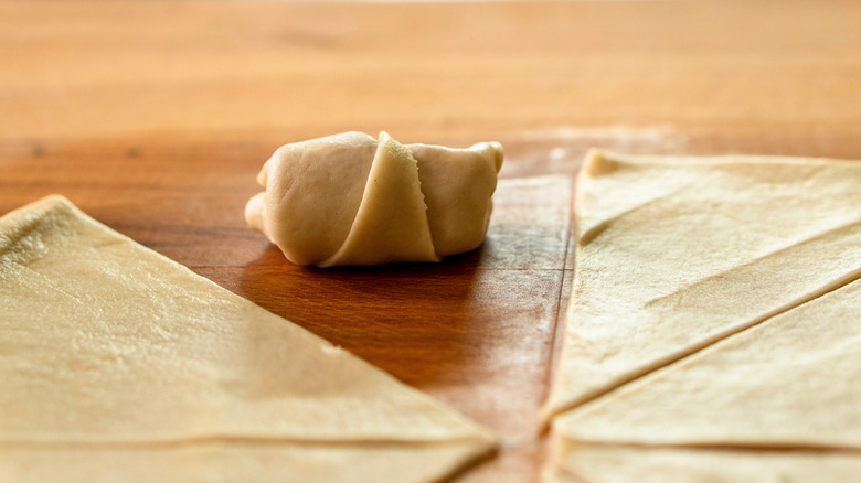 A crescent roll and unrolled dough.
