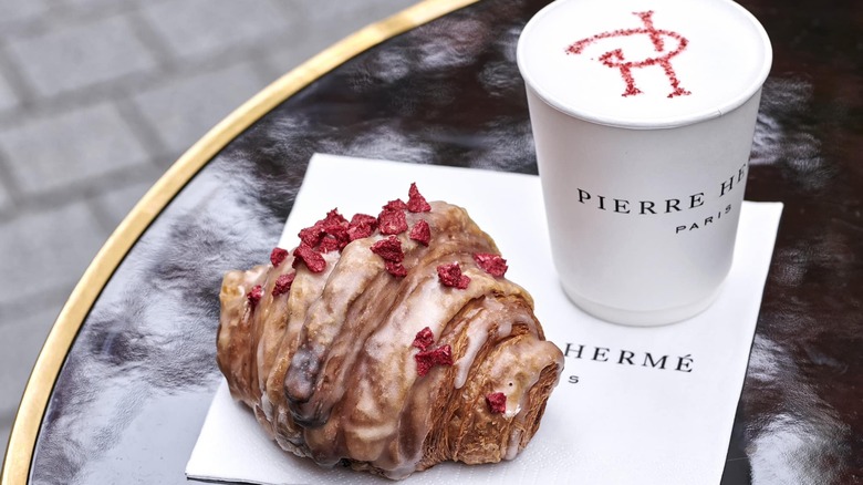 Ispahan croissant and coffee on table