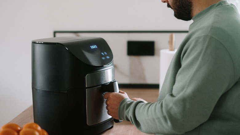 Man cooking with air fryer