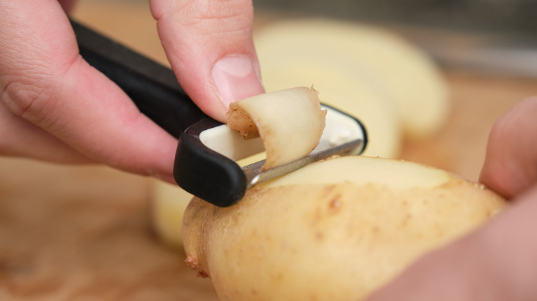 Man peeling a potato