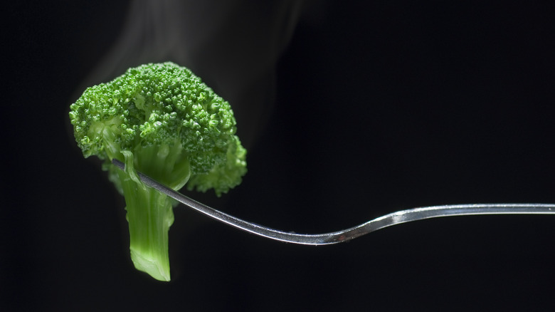 Steamed broccoli with fork