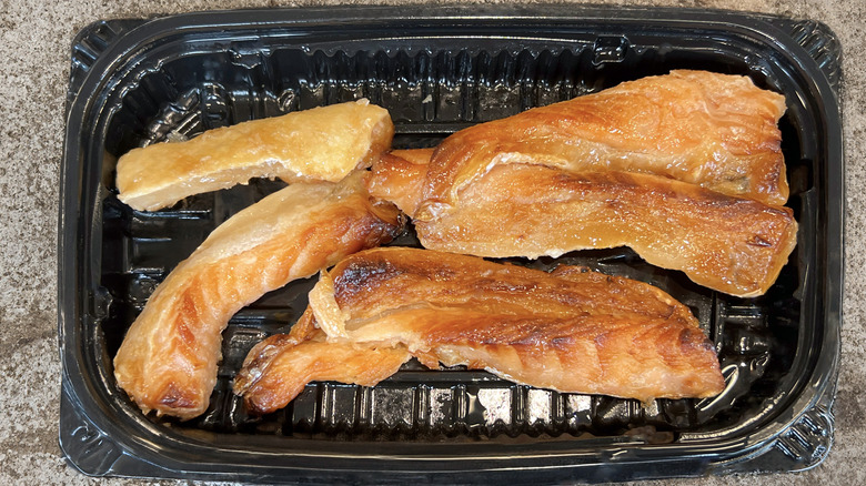 Grilled salmon bellies in tray