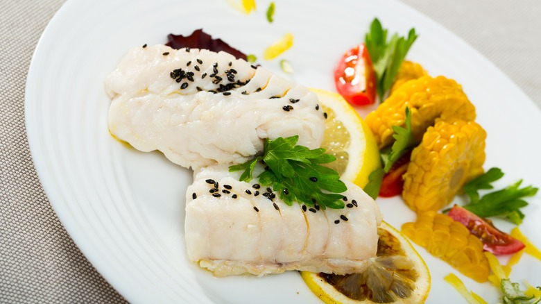 Cooked hake filets on plate