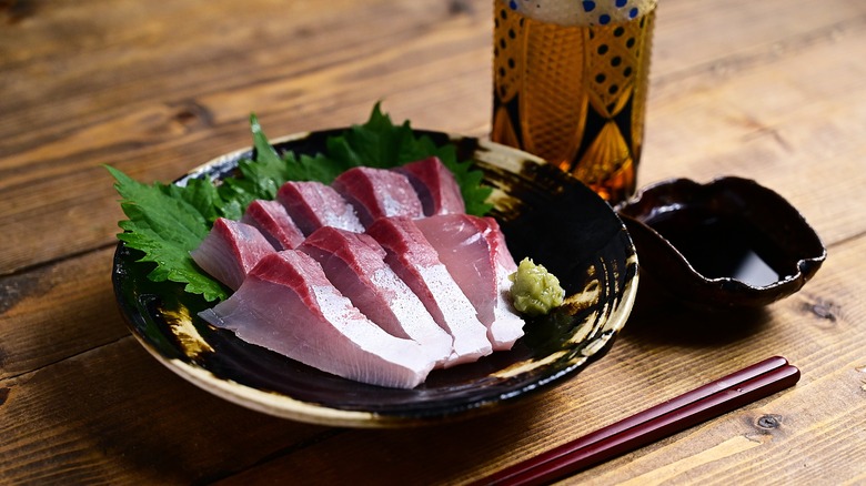 Kanpachi sashimi on black plate