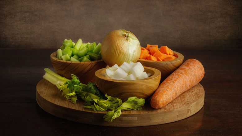 mirepoix ingredients on wooden board