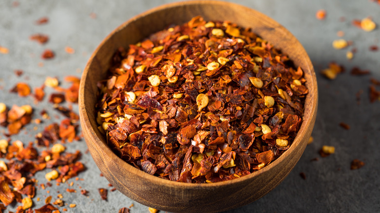 red chilli flakes wooden bowl