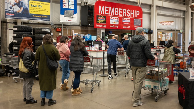 Customers walking past a membership counter inside a Costco